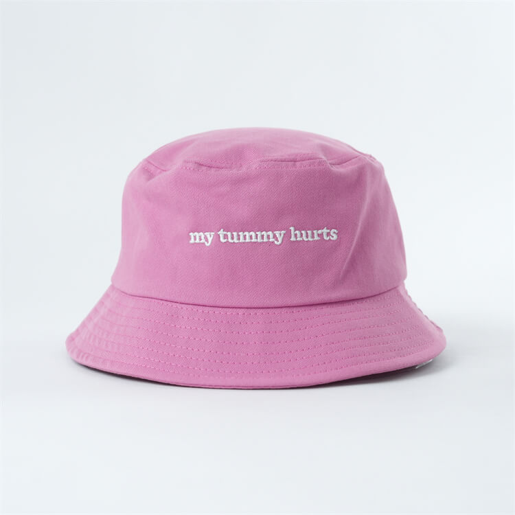 Pink bucket hat with 'my tummy hurts' text in white