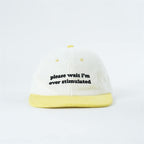 please-wait-im-overstimulated-yellow-cap
