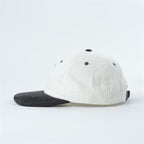 side-view-black-and-white-cap-trash-panda